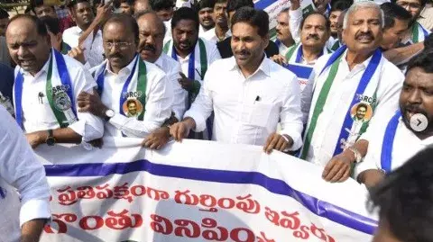 దేవుడి ఫోటోలతో నిరసన నేరమా? టీడీపీ డిమాండ్ ఉద్దేశం ఏమిటీ?